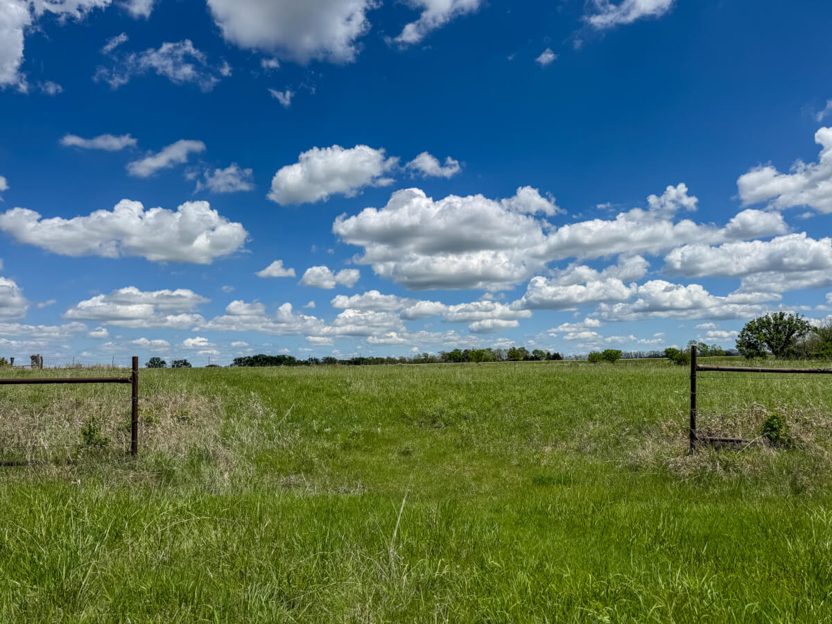 Buying rural property in Kansas with open pasture and fence line